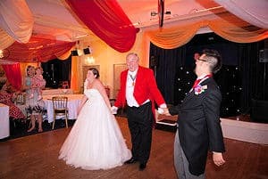 Guy Boyling as toastmaster celebrating with a bride and groom on the dance floor